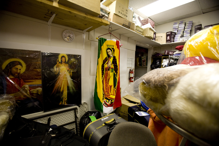 A Virgen of Guadalupe blanket sits in the back of a dollar store owned by a 