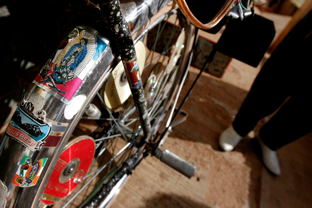 El Bulico (the rooster as he is known in town) shows off his bike decorated with decals of the Virgen of Guadalupe and anything else he's found while working in the states from the past thirty years.